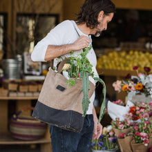Two-tone canvas tote bag with top handles and front logo patch, open-top