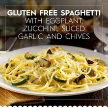 Gluten-free spaghetti plate with vegetables, herbs, and grated cheese