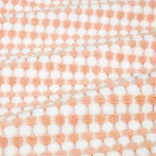 Pink bath towel with repeating small check texture
