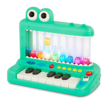 Green crocodile pop-up piano toy with keyboard keys and colorful character drums