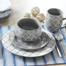 Gray dinner plate with white quatrefoil trellis pattern and dot medallions