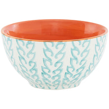 White serving bowl with teal scroll pattern and coral orange interior.