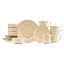 Sand ribbed dinnerware set with stacked plates, bowls, and mugs on display