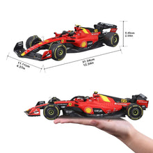 Red and black Formula race car model with Ferrari-style graphics, held in a hand