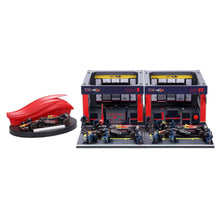 Formula racing paddock set with open garage bays, mini cars, and red display dome