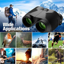 Black compact binoculars on a backpack outdoors, side-angle view