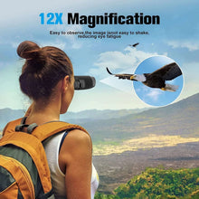 Black binoculars held to the eyes by a person, outdoor landscape view