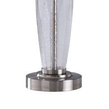Table lamp with clear textured glass column and round brushed metal base