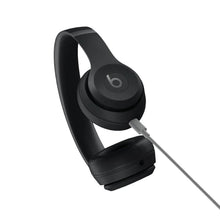 On-ear wireless headphones, matte black with connected cable and circular power button