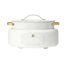 White electric multi-cooker with lid, gold handles, front touchscreen controls