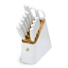 White handled stainless steel knife block set with 12 knives in a white block