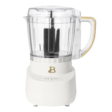 Drew Barrymore 3-cup food chopper with clear bowl, black blade, and white base