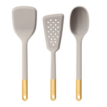Silicone kitchen utensil set in gray: spatula, slotted turner, and spoon with gold handle