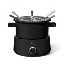 Black electric fondue pot with lid and six colored fork handles
