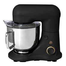Black stand mixer with balloon whisk attachment and stainless mixing bowl