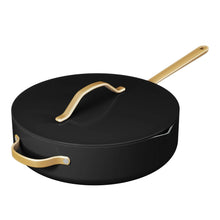 Black ceramic sauté pan with strainer lid and gold-tone handles