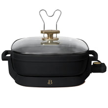 Electric skillet with glass lid and brass-toned center knob, black base