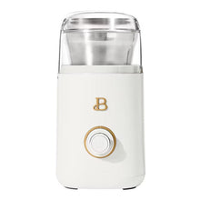 White electric blade coffee grinder with clear lid and gold-trimmed power button