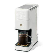 White single-serve programmable coffee maker with black drip tray and side viewing window