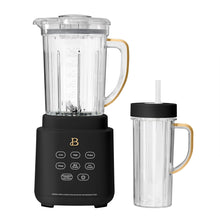 Black blender base with clear blending pitcher and black-lidded to-go cup, gold handles