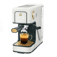White espresso machine with steam wand and cup of espresso