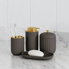 Grey toothbrush holder with matching accessories and gold-toned pump tops