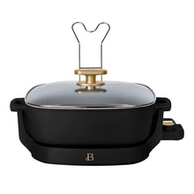 Black electric skillet with glass lid, gold handle, side grips, and temperature control