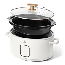 White programmable slow cooker with glass lid and black base with gold knob