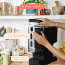 Black single-serve coffee maker with removable 64-ounce water reservoir and charcoal filter