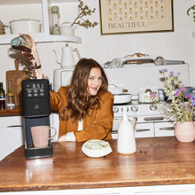 Beautiful by Drew Barrymore coffee maker shown brewing coffee into a mug
