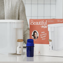 Beautiful by PUR water filter dispenser with blue filter cartridge and retail box