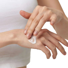 White skincare cream applied on hands, dollop on palm