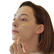 Eye serum applied under the eye as light green gel