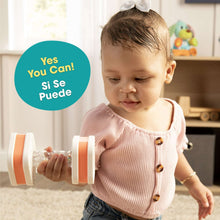 Orange-and-white twist-and-shake dumbbell baby toy with clear beads in both ends