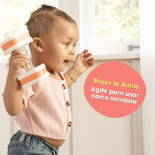 Orange-and-white twist-and-shake dumbbell baby toy with clear beads inside, side held