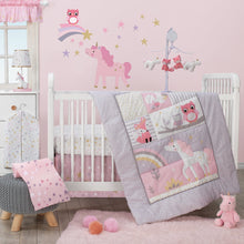 Pink unicorn plush toy on bedroom floor near baby bedding