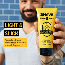 Bee Bald premium shaving cream tube held in hand, yellow/black, head & face, 6 fl oz