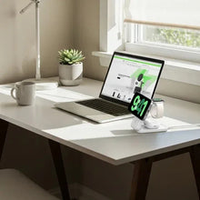 White 3-in-1 Qi charging stand with a smartphone displaying an active green charge