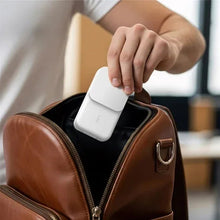 White 3-in-1 Qi charging stand with a smartphone being placed on the cradle