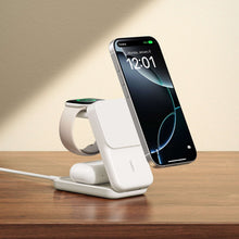 White 3-in-1 Qi charging stand with a smartphone seated and green status light