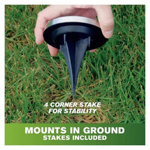 Solar disk light stake being inserted into grass for in-ground mounting