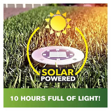 Solar-powered disk light on grass, round stainless-steel face with bright LED array