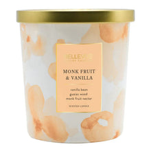 Scented candle jar with gold lid, peach and cream marbled wax, label reads Monk Fruit & Vanilla