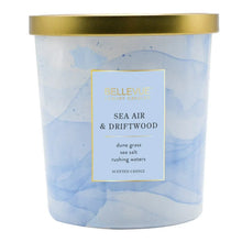 Scented candle jar with gold lid, blue marbled wax, label reads Sea Air & Driftwood