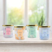 Bellevue luxury candle set of four 12oz jars with gold lids and pastel labels.