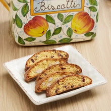 Ceramic biscotti jar with fruit-and-leaf decoration; sliced biscotti on white plate