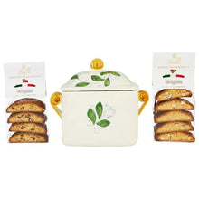 Covered ceramic biscotti jar with fruit-and-leaf pattern and gold knobs; two cookie packs