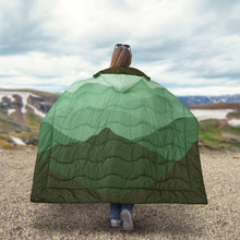 Green wearable blanket with hood, quilted wavy stripes