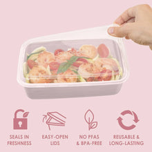 Pink meal prep container with lid, filled with sliced food