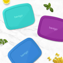 Set of three lunch box lids in teal, purple, and blue with bentgo logo.